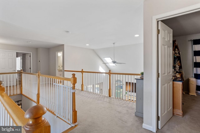 hall with vaulted ceiling and carpet floors