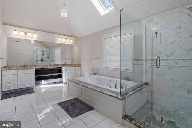 bathroom with vanity, vaulted ceiling with skylight, and separate shower and tub