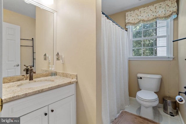 bathroom featuring tile patterned floors, toilet, and vanity