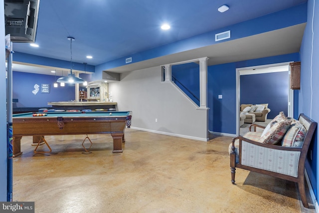 game room featuring bar, concrete flooring, and pool table