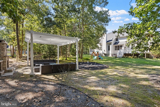 view of yard featuring a playground, a pergola, and an outdoor hangout area