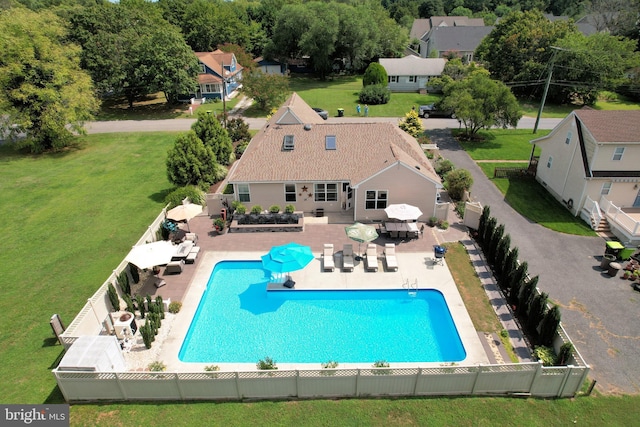 view of pool featuring a lawn and a patio