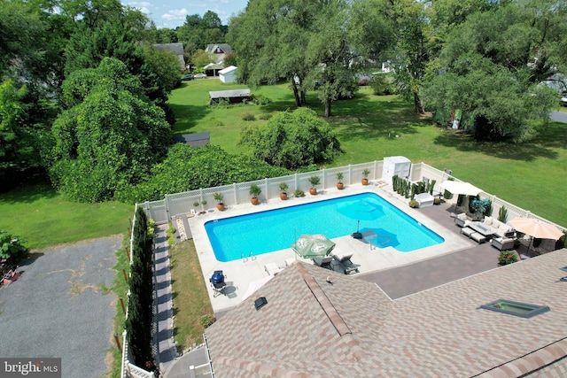 view of swimming pool featuring a lawn and a patio area