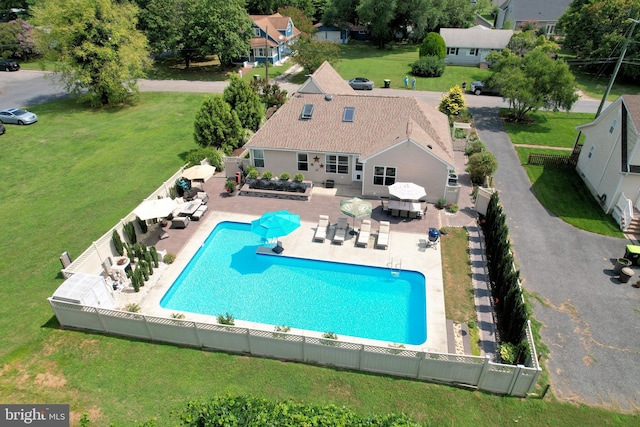 view of swimming pool featuring a yard and a patio area