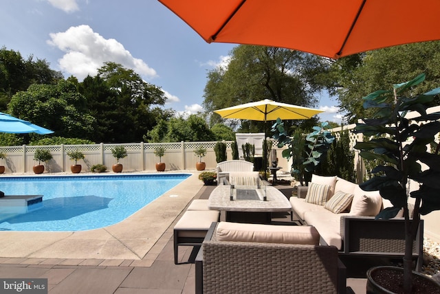 view of swimming pool with outdoor lounge area and a patio area