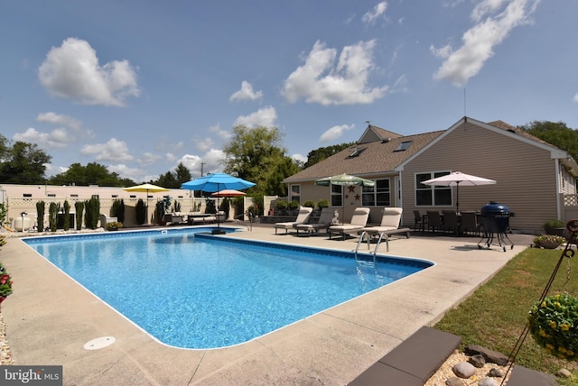 view of swimming pool with a patio area