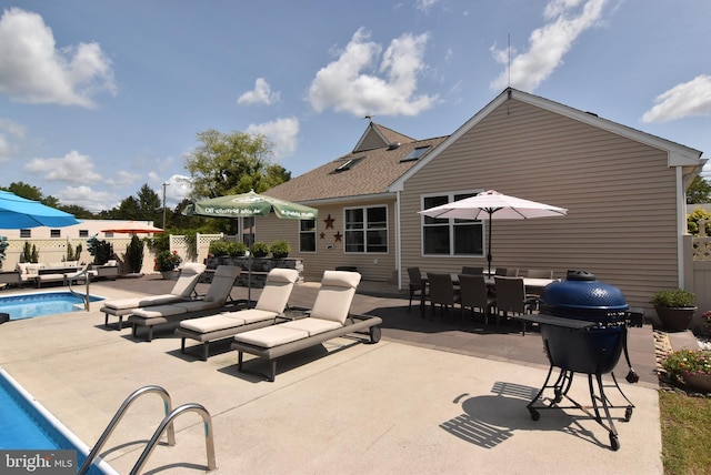 view of patio / terrace with a fenced in pool