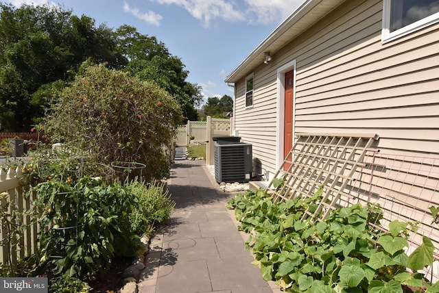 view of side of home with central air condition unit