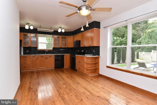 kitchen with light hardwood / wood-style flooring, black appliances, ceiling fan, and backsplash