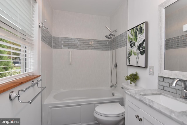 full bathroom with tiled shower / bath, vanity, backsplash, and toilet