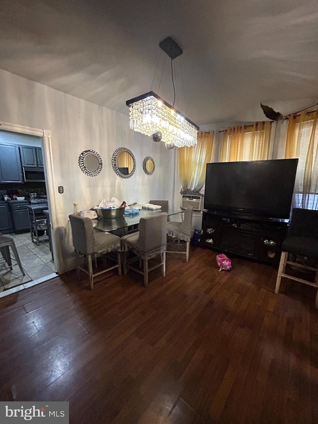 dining area featuring a notable chandelier and hardwood / wood-style floors