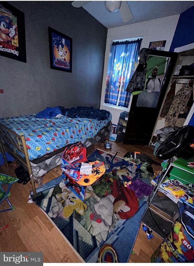 bedroom with wood-type flooring and ceiling fan