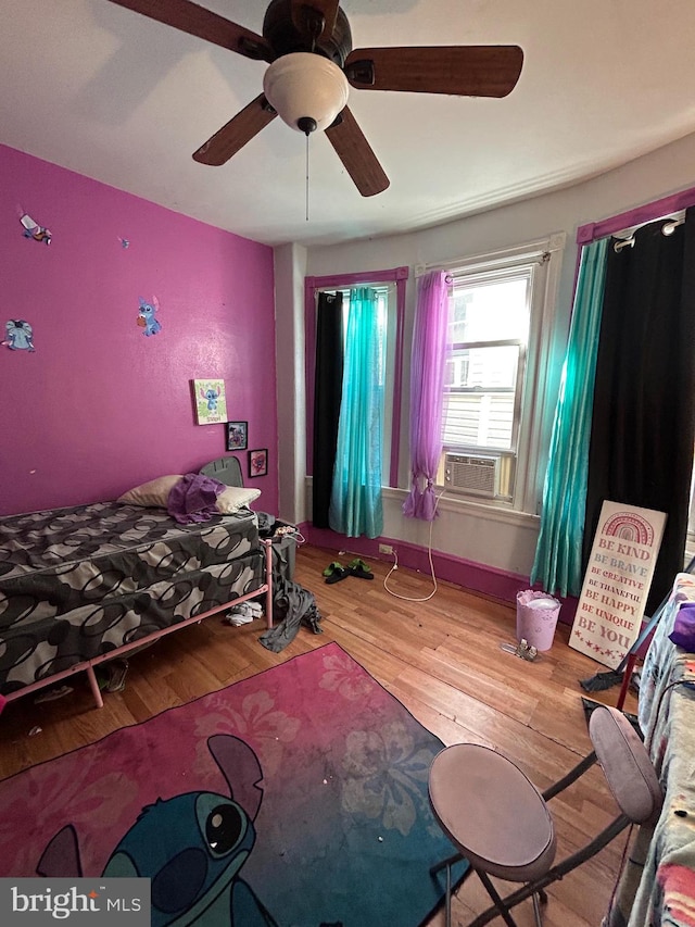 bedroom with ceiling fan and hardwood / wood-style flooring