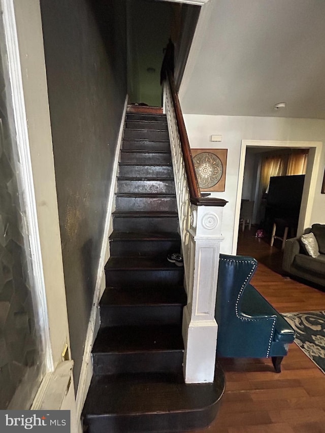 stairs featuring hardwood / wood-style flooring