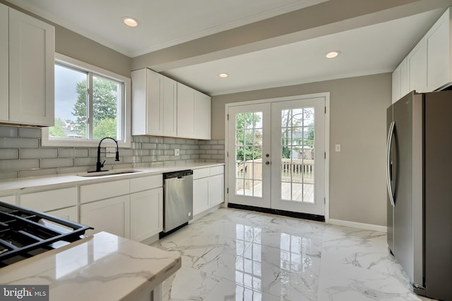 kitchen featuring sink, french doors, white cabinets, and appliances with stainless steel finishes