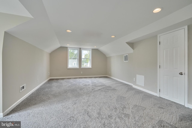 bonus room featuring lofted ceiling and carpet floors