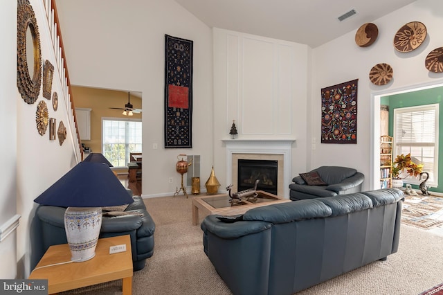 carpeted living room featuring lofted ceiling and ceiling fan