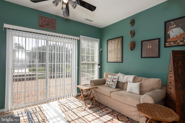 living room featuring ceiling fan and plenty of natural light