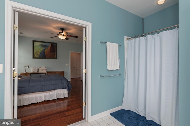 bathroom with ceiling fan and hardwood / wood-style flooring