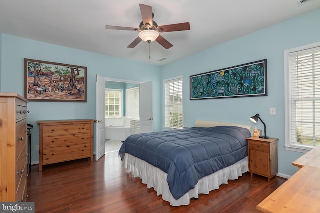 bedroom featuring ceiling fan, ensuite bath, and dark hardwood / wood-style floors