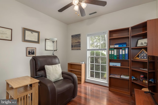 sitting room featuring dark hardwood / wood-style floors and ceiling fan