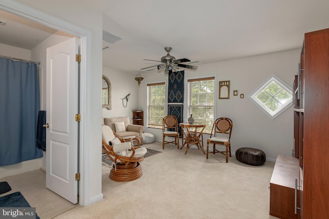 sitting room featuring ceiling fan and light colored carpet