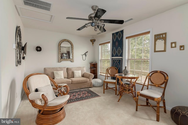 living room featuring ceiling fan and light colored carpet