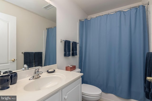 bathroom with vanity, toilet, and walk in shower