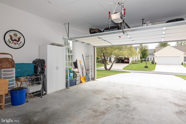 garage featuring a garage door opener and a lawn