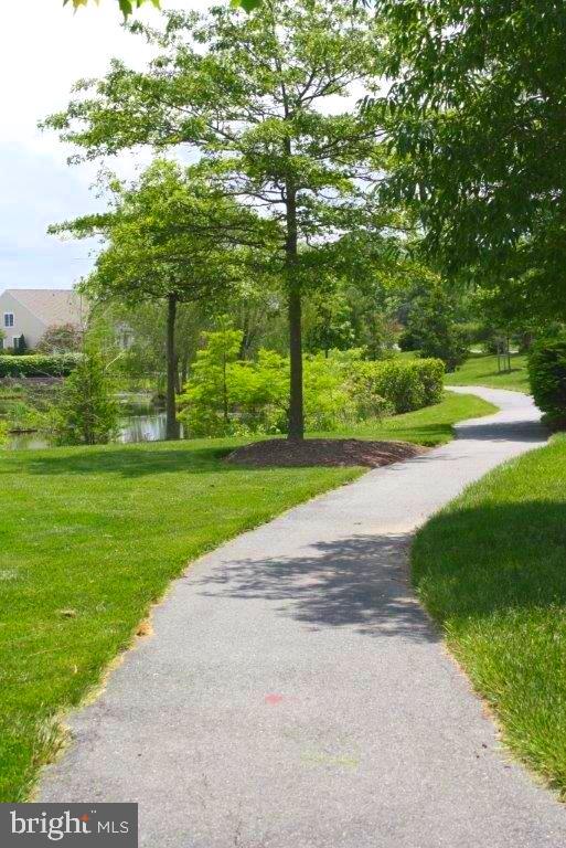 view of property's community featuring a water view and a lawn