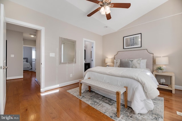 bedroom with vaulted ceiling, hardwood / wood-style floors, and ceiling fan