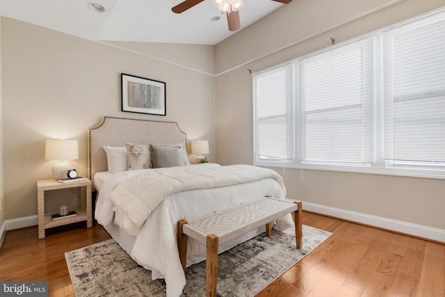 bedroom featuring ceiling fan, lofted ceiling, and wood-type flooring