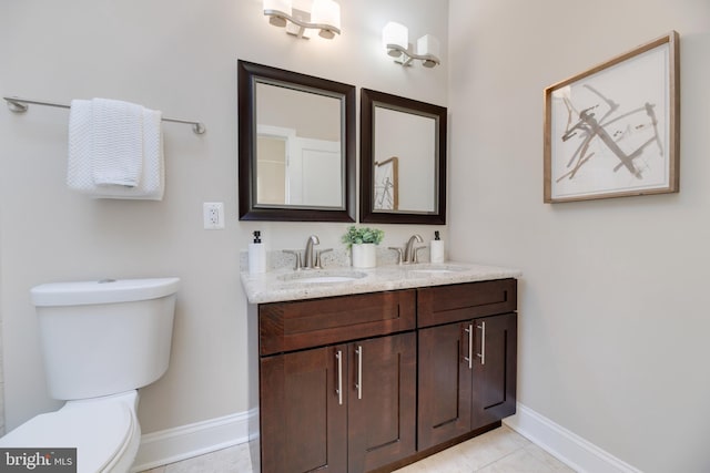 bathroom featuring vanity, tile patterned flooring, and toilet