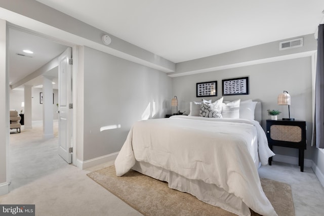 bedroom with light colored carpet