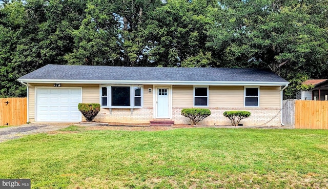 single story home featuring a garage and a front lawn