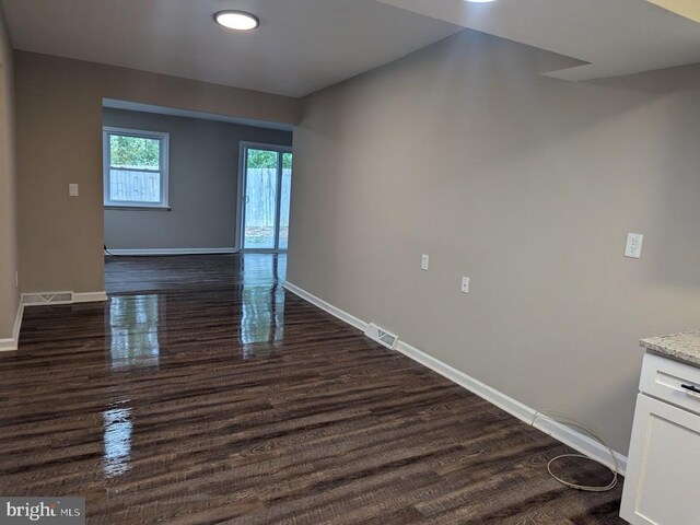 unfurnished room featuring dark wood-type flooring