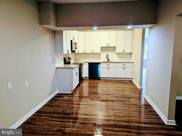 kitchen with dishwasher, dark wood-type flooring, sink, white cabinetry, and electric stove