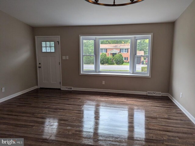 entrance foyer with dark hardwood / wood-style floors