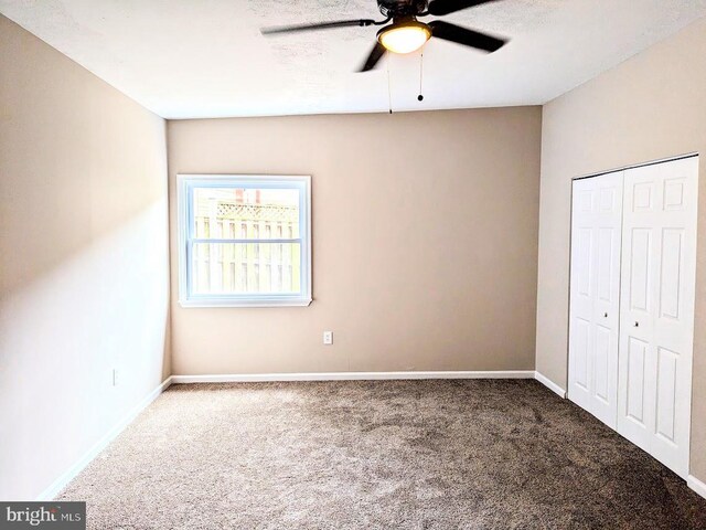 unfurnished bedroom with a closet, ceiling fan, and carpet