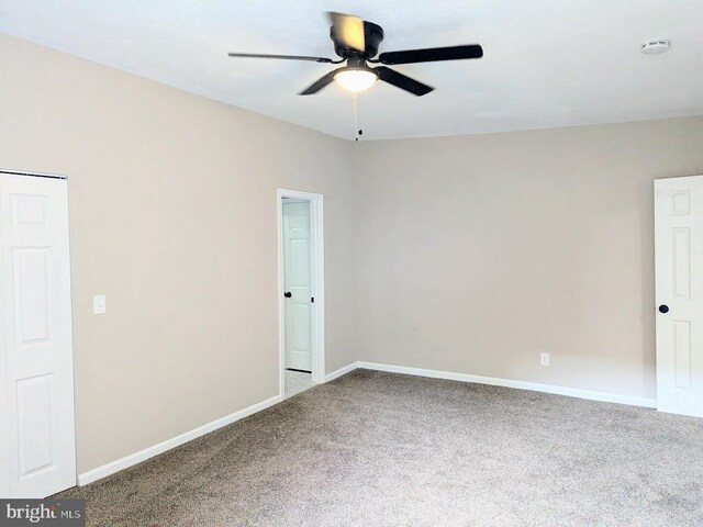 carpeted empty room with ceiling fan