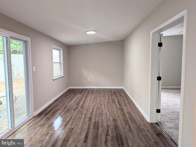 spare room with dark wood-type flooring