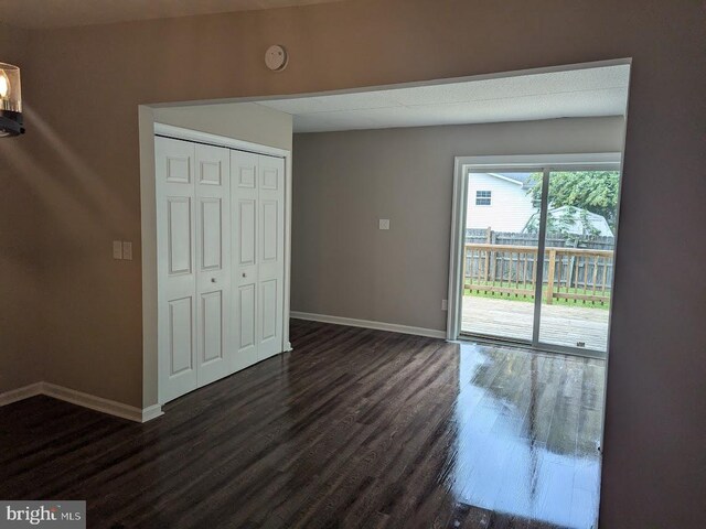 empty room with dark hardwood / wood-style floors