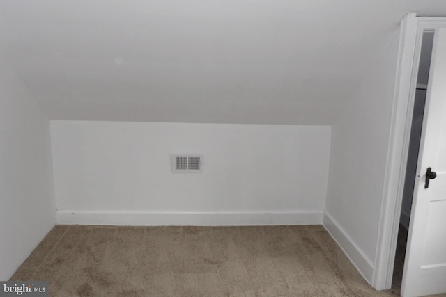 additional living space with vaulted ceiling and light colored carpet