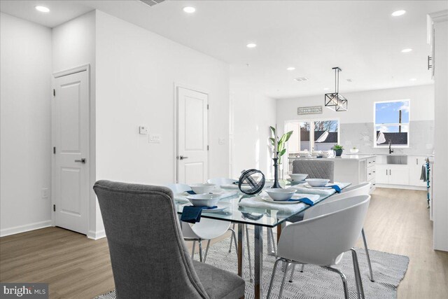 playroom featuring sink and light hardwood / wood-style flooring