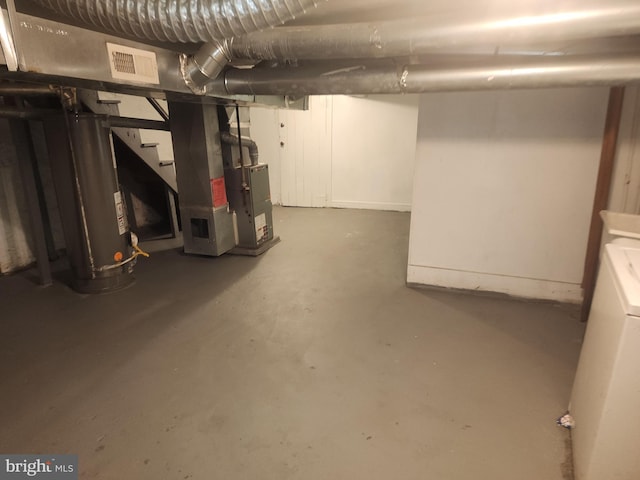 basement featuring washer / clothes dryer and heating unit