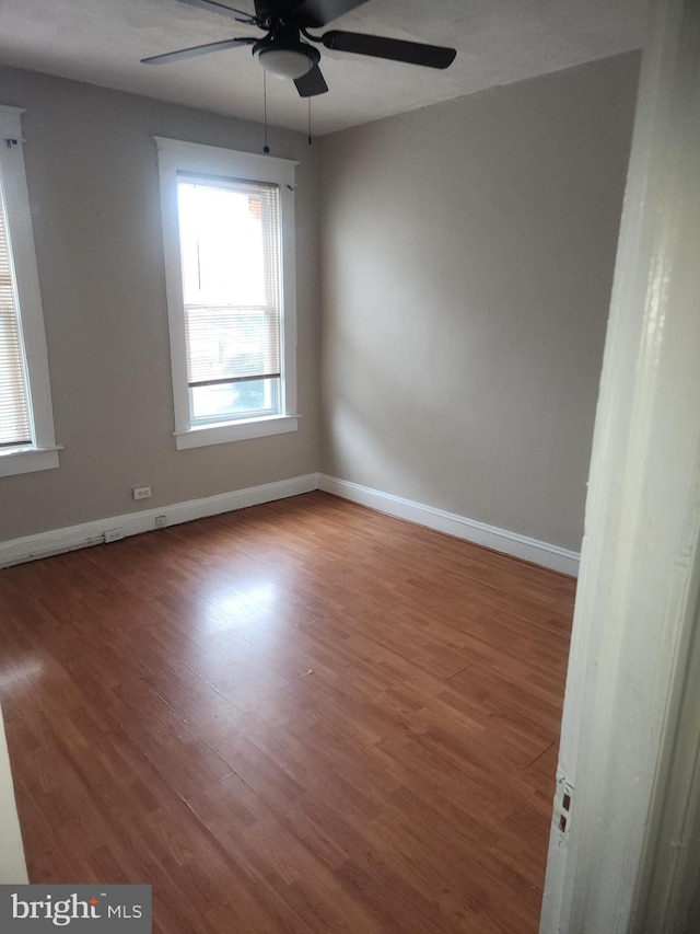 empty room featuring hardwood / wood-style floors and ceiling fan