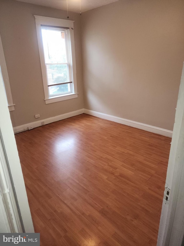 spare room with hardwood / wood-style floors