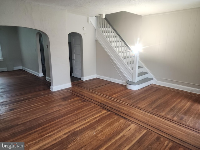 interior space with a textured ceiling and wood-type flooring