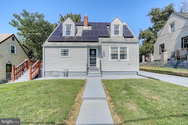 cape cod house with solar panels and a front lawn