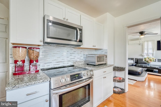 kitchen featuring appliances with stainless steel finishes, white cabinetry, and ceiling fan